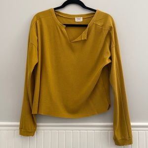 Cropped yellow long sleeve shirt.